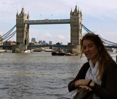 A photo of a student with the London bridge behind them 