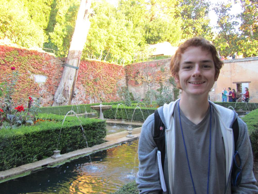 Wheaton student in Granada garden courtyard 