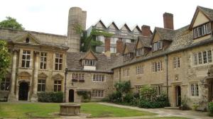 Courtyard at St Anne's College, with several stone buildings surrounding the green space.